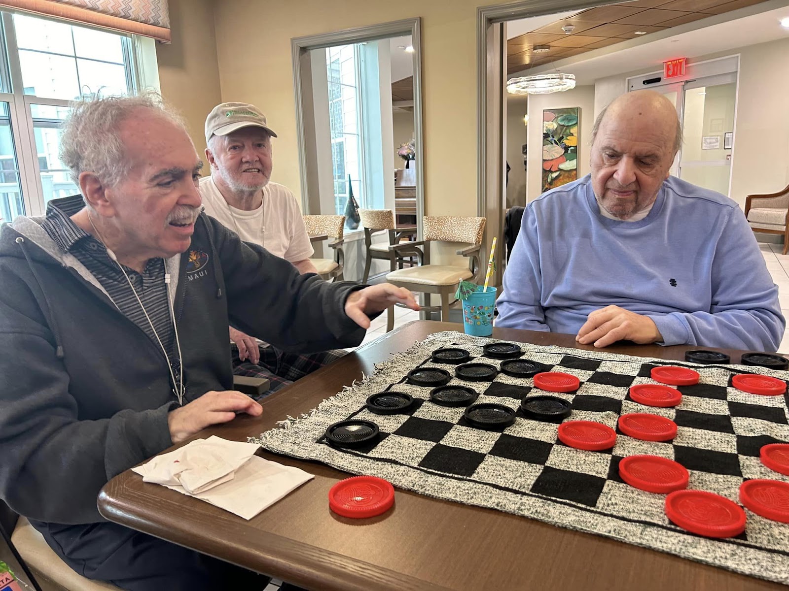 Elderly citizens in a memory care playing checkers