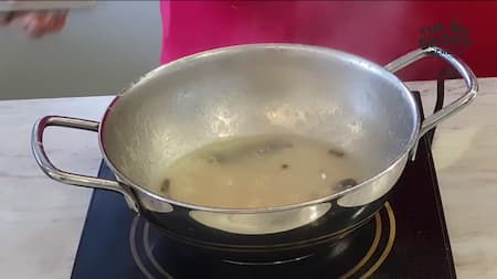 Onion paste being cooked with spices until oil separates for Chicken Kali Mirch.