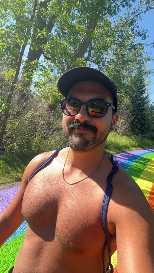 Phil gay xxx porn creator and influencer taking outdoor phone selfie on rainbow walkway to Hanlan's nude beach on toronto city island