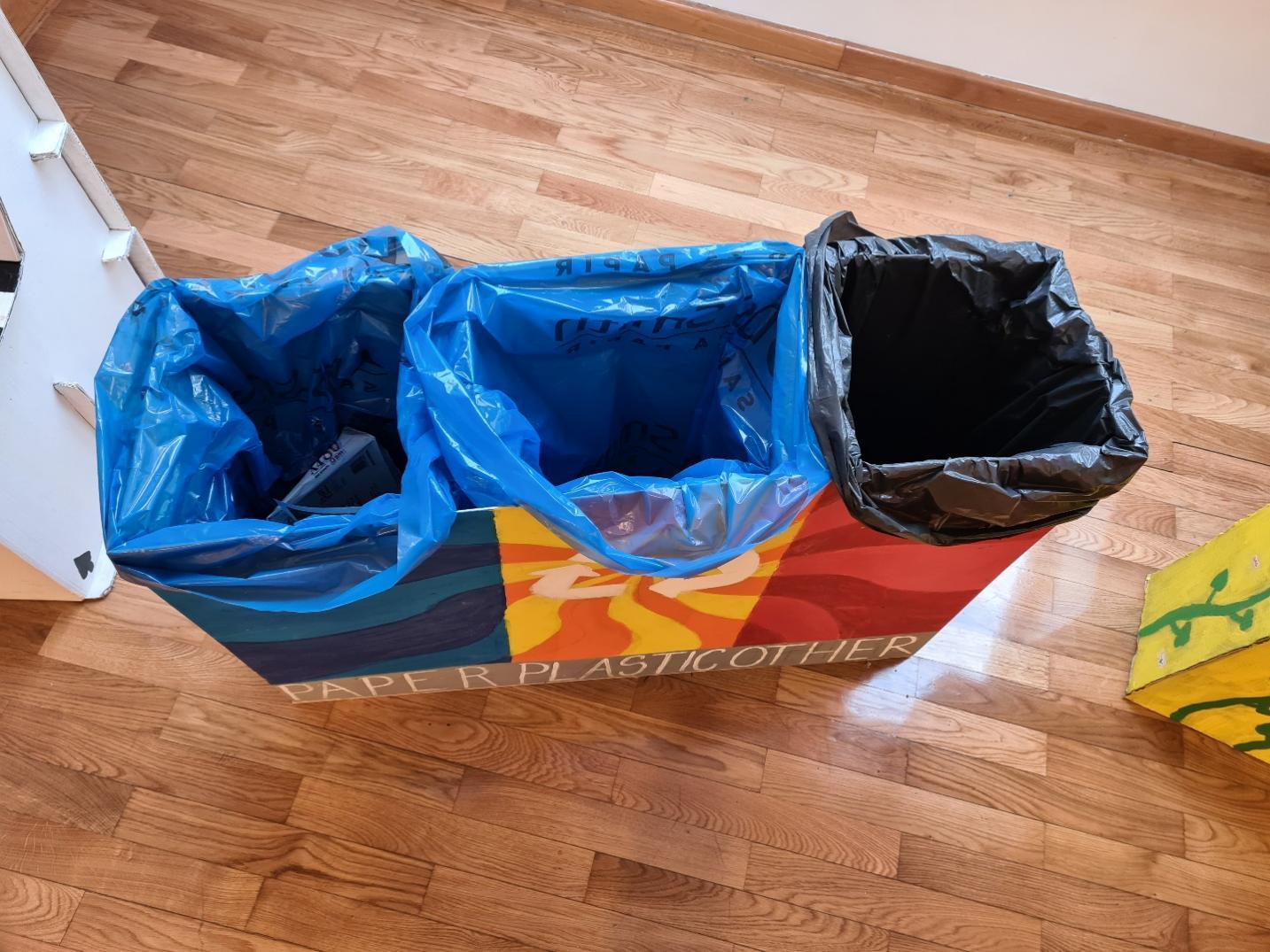 A garbage bag on a wood floor

Description automatically generated