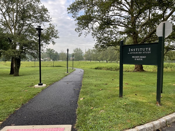 sign reading “Institute for Advanced Study” beside a path through a grass field