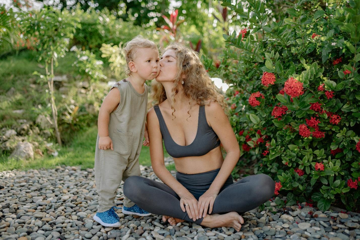 A person and child kissing Description automatically generated