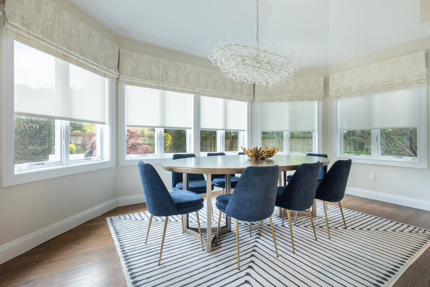 Dining area with roller shades in the background