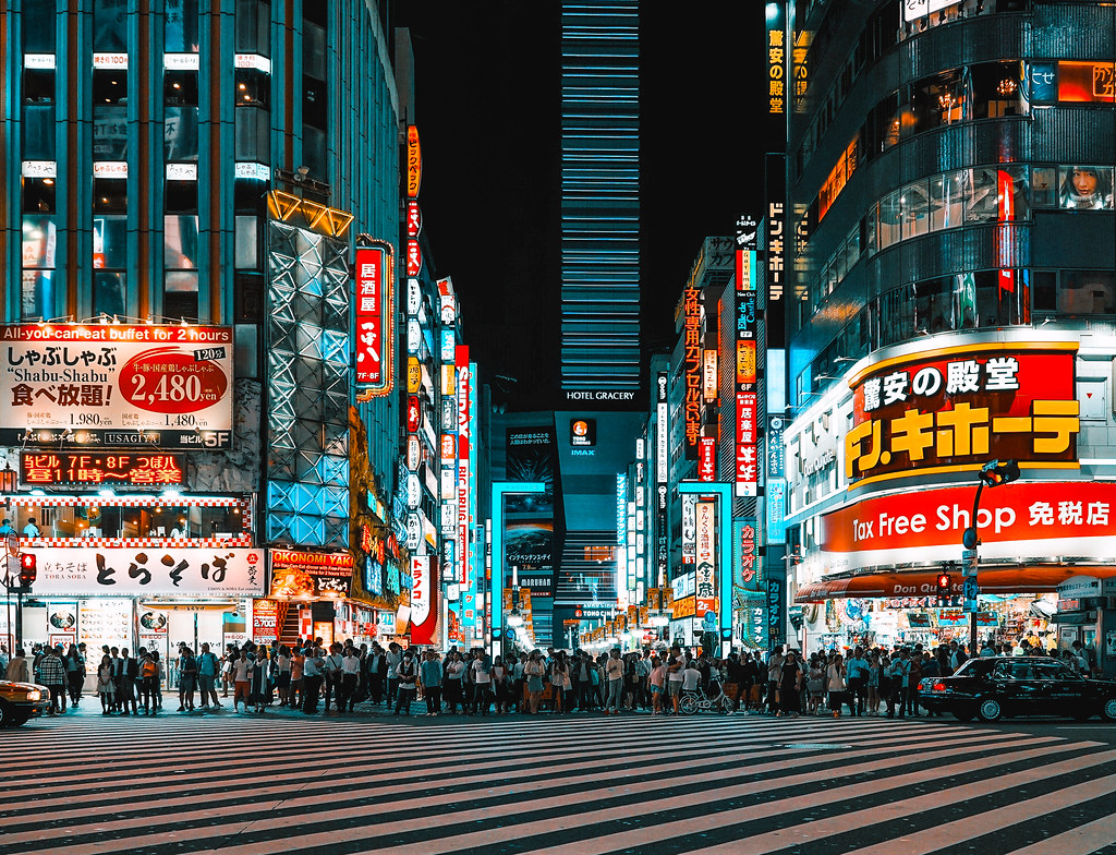 Shows a picture of a bustling city in Tokyo enhanced with the help of VSCO editing option.