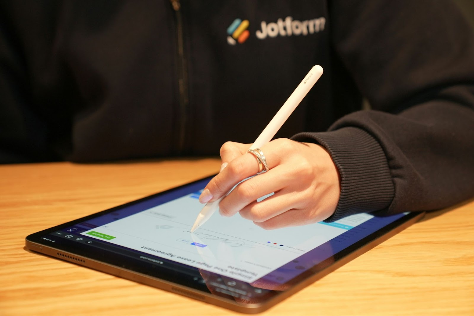 a person signing a life insurance policy on a tablet