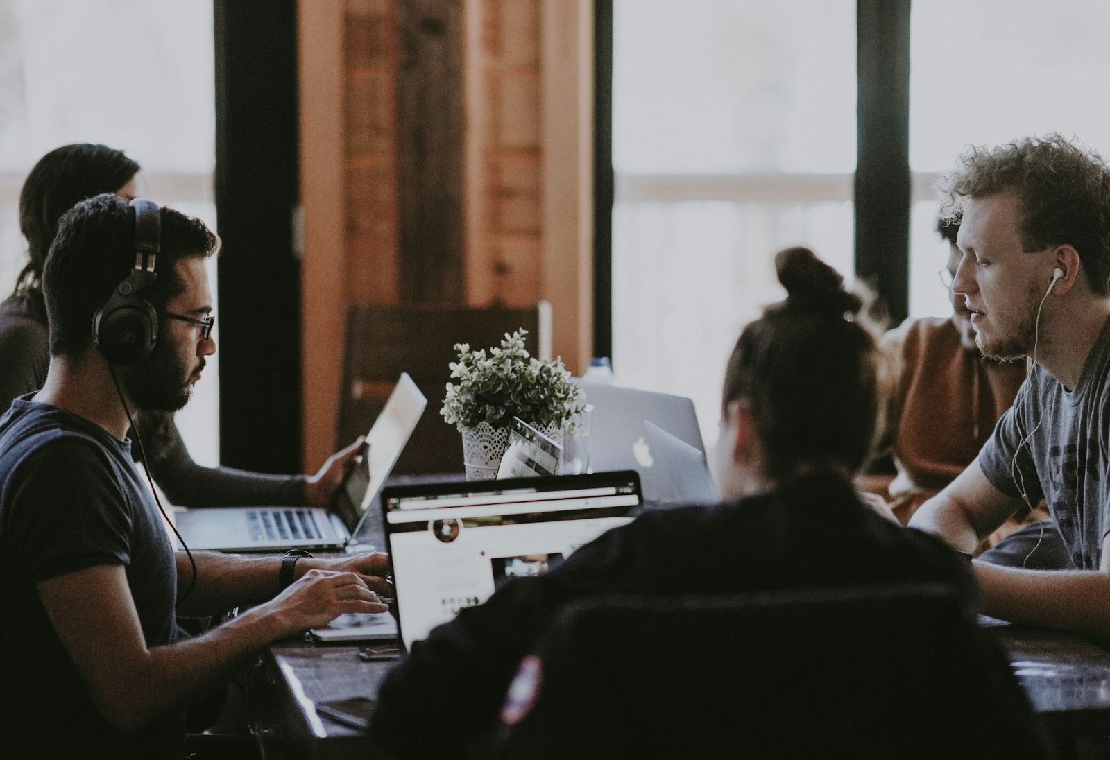 Group of people working on their laptops at a table