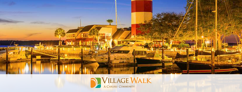 A Village Walk banner of a sea harbor in the evening