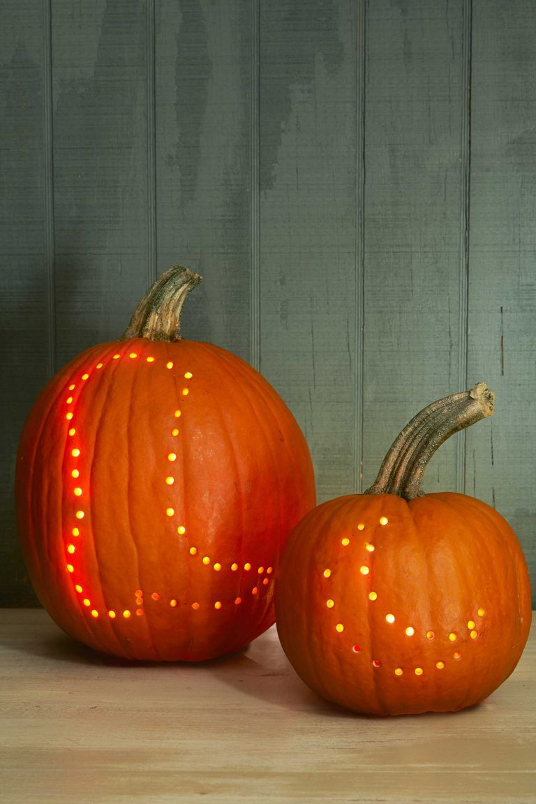 pumpkin carving ideas, two pumpkins, one with a drilled boot design and the other with a moon design