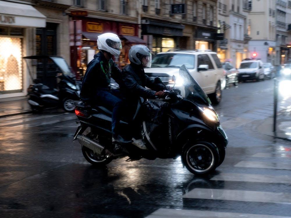 Free A Man in Black Jacket Riding Black Motorcycle on the Road Stock Photo