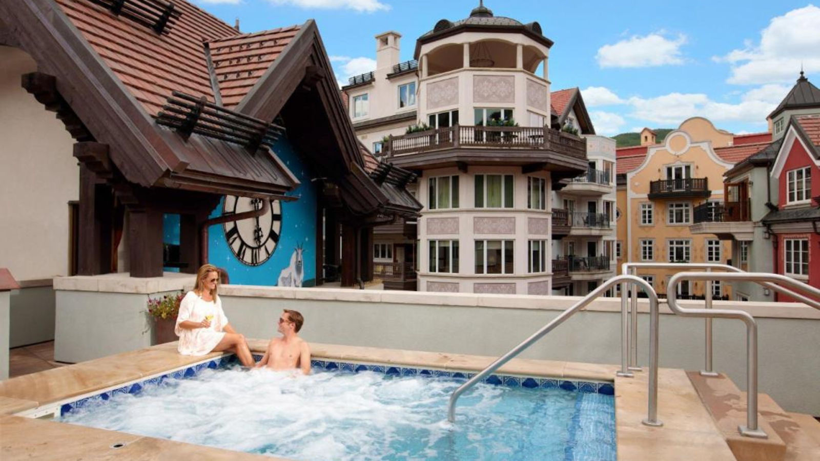 A man and a woman relaxing at an outdoor pool of a hotel in Vail, CO | Photo credit: The Arrabelle at Vail Square