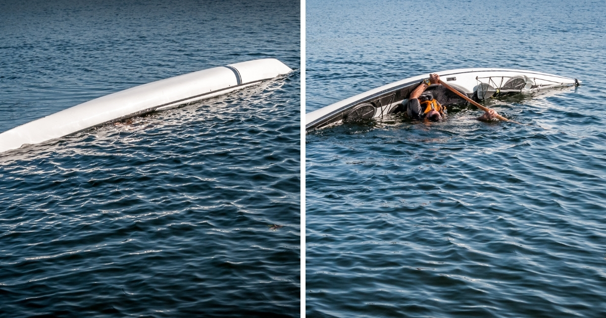 Man doing a kayak roll on a lake.