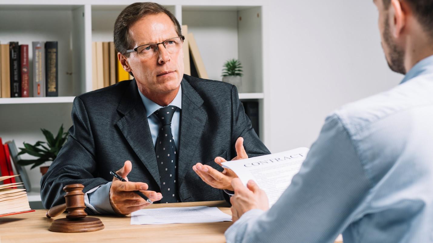 A man consulting a lawyer about back taxes
