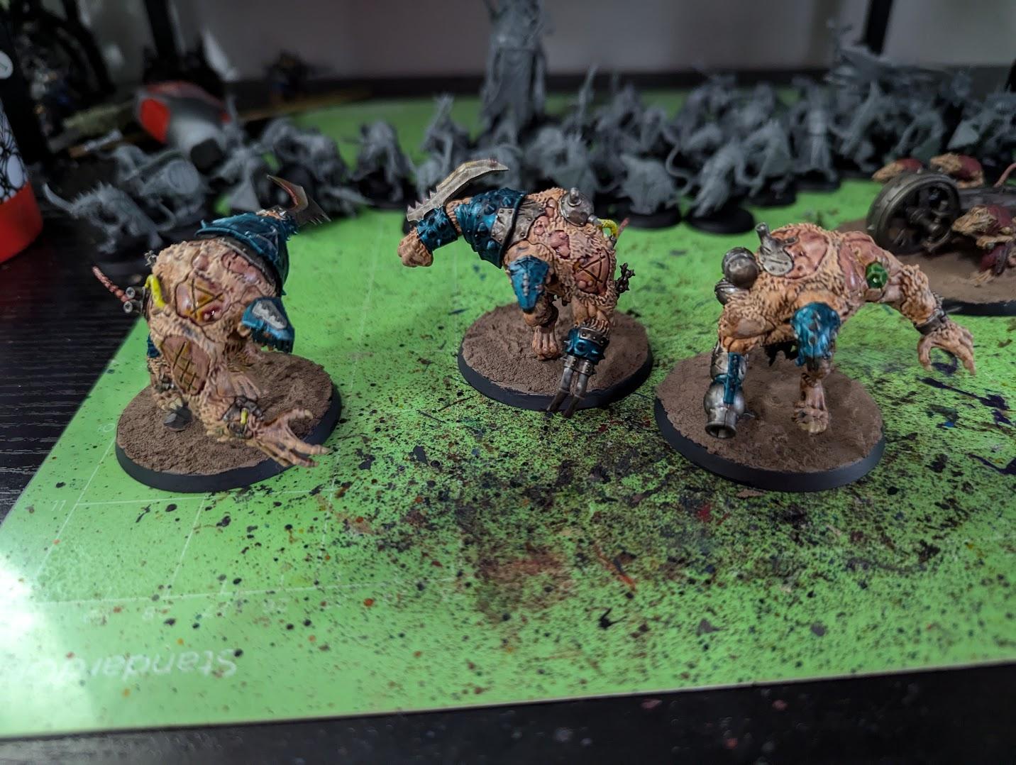 A group of figurines on a green surface  Description automatically generated