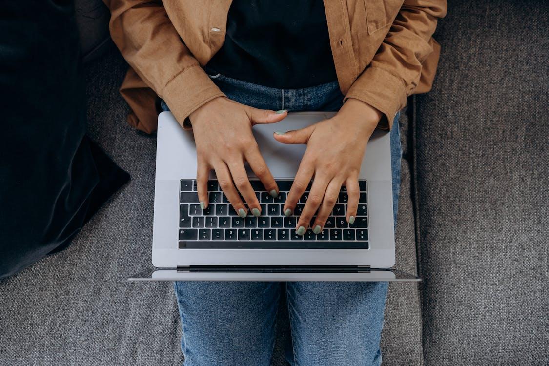 Free Top View of a Person Typing on a Laptop Stock Photo