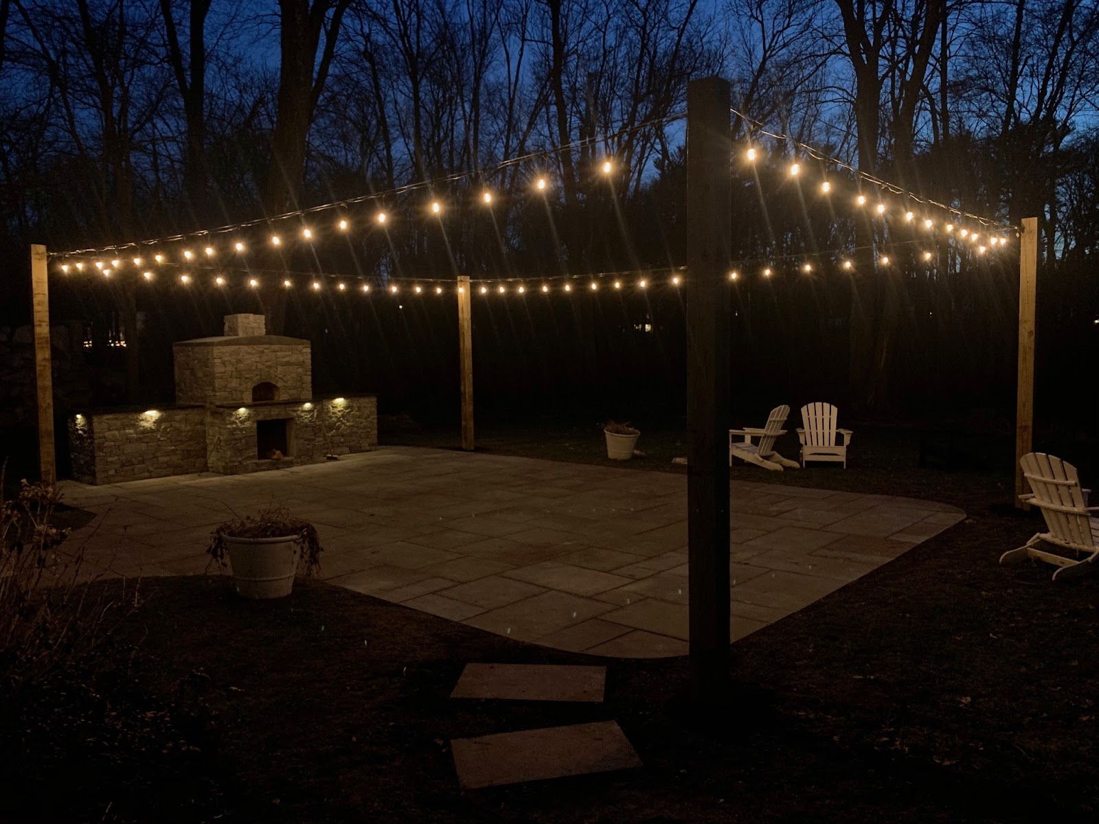 Landscape lighting includes string lighting over a patio