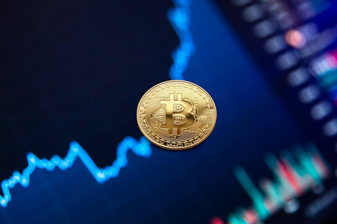 Free Gold bitcoin coin on background of growth chart Stock Photo