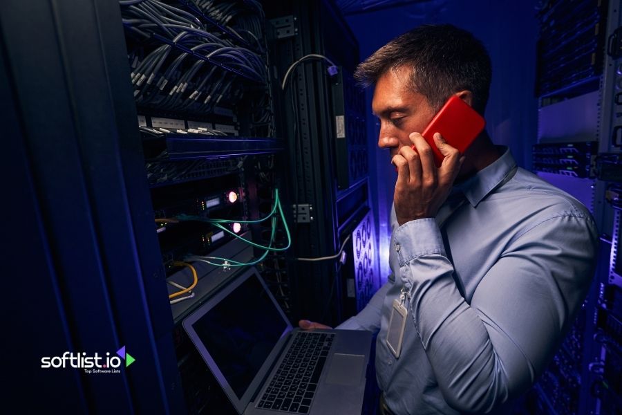 Technician talking on phone while managing servers.