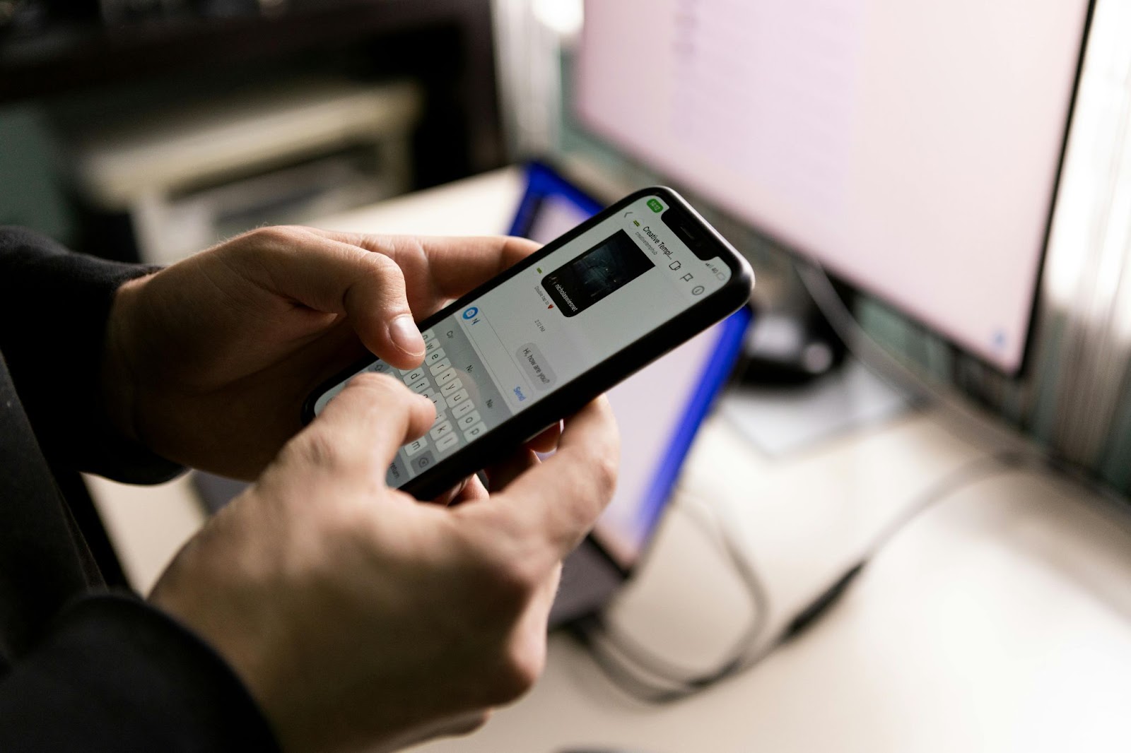 Person typing on a smartphone, composing a message