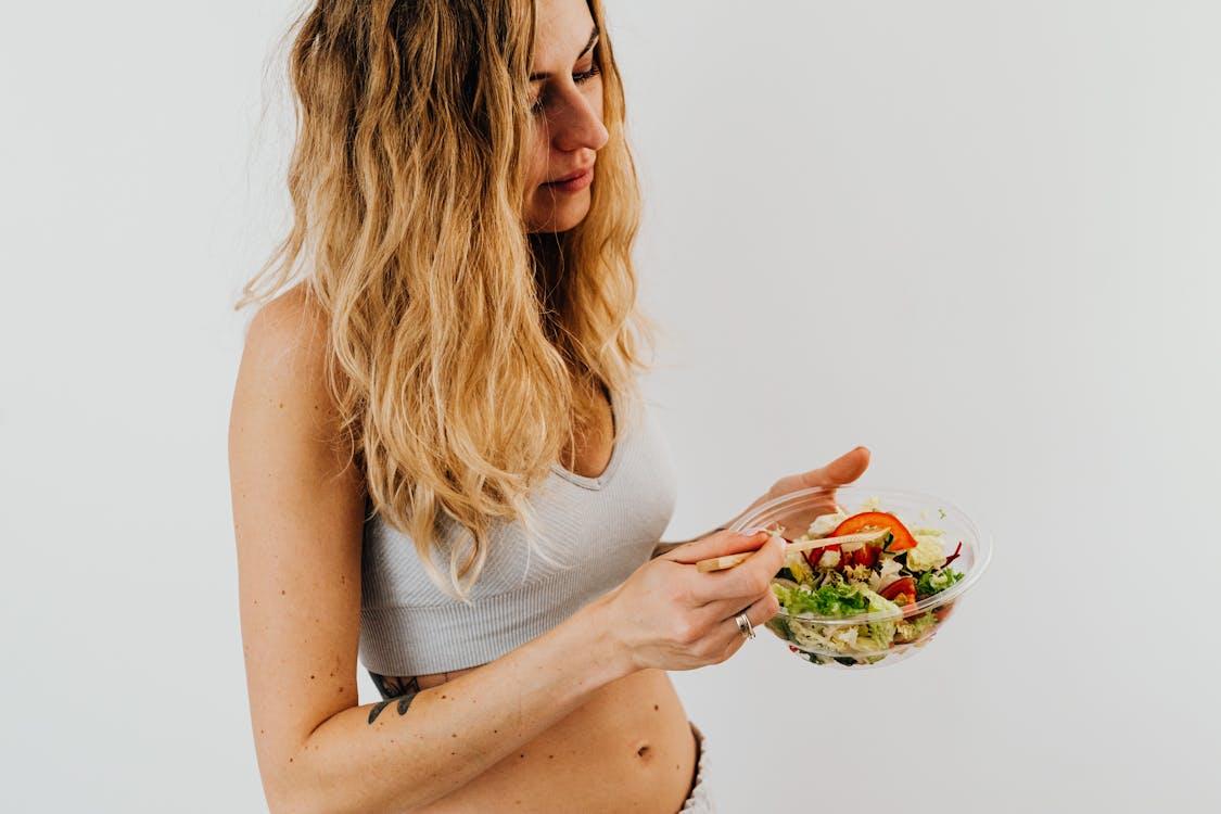 Free Woman in White Sports Bra Holding a Bowl of Salad Stock Photo