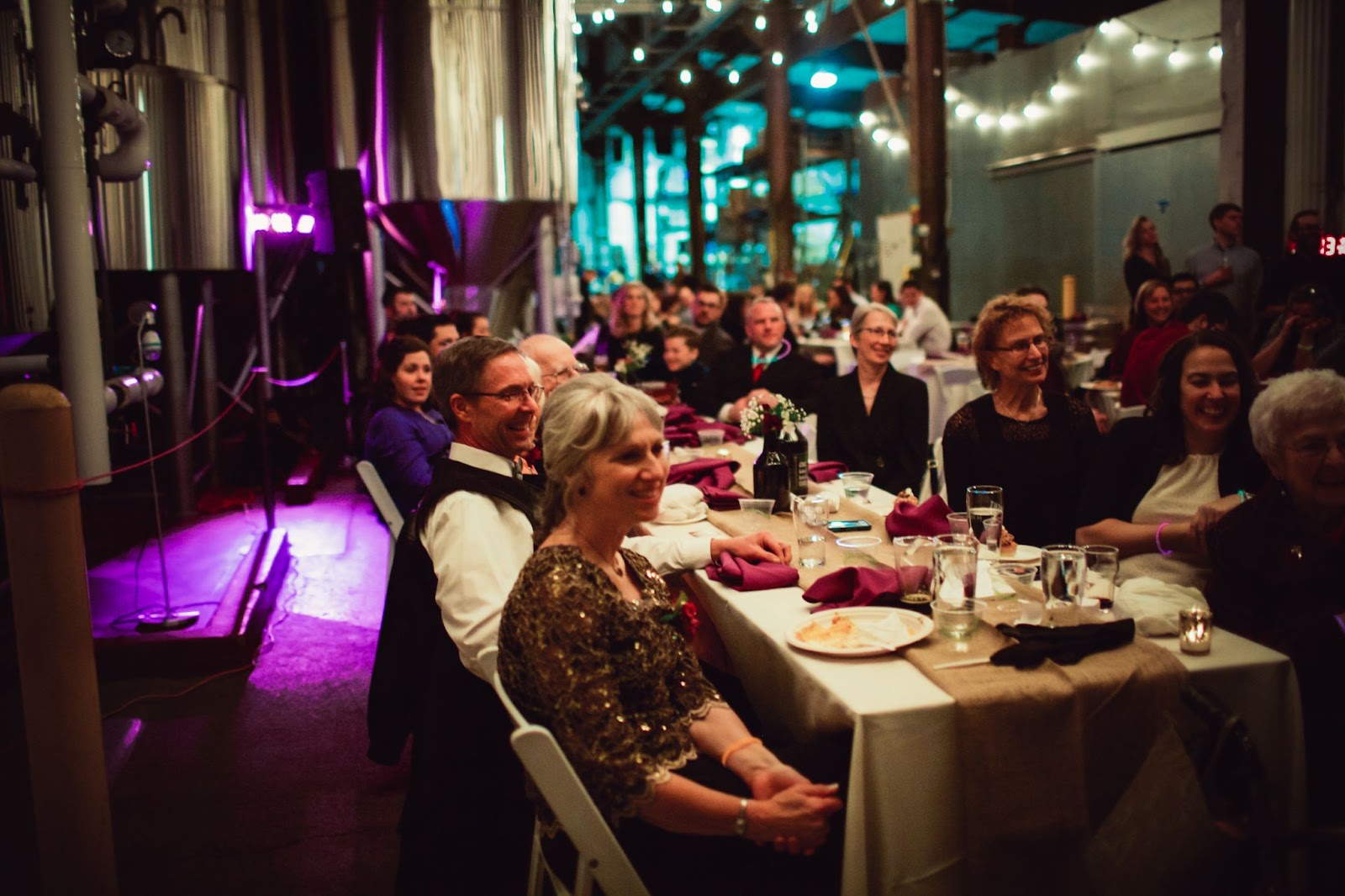 Event rental space in production brewery showing Wedding guests seated at table 