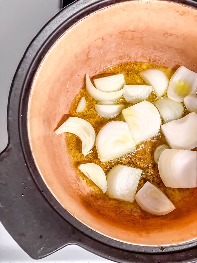 Sautéing onions in a large pot.