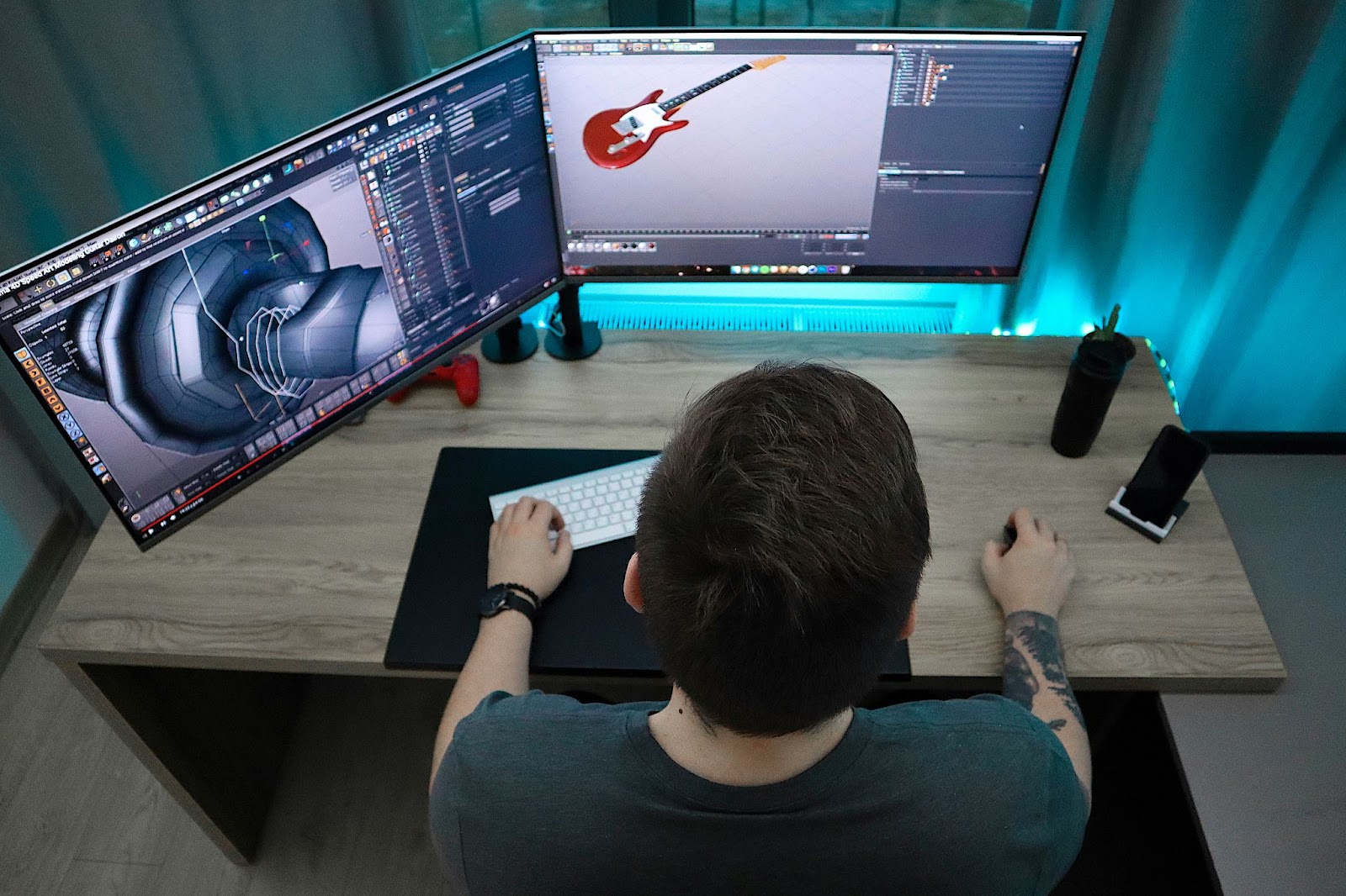 A person sitting at a desk with two monitors