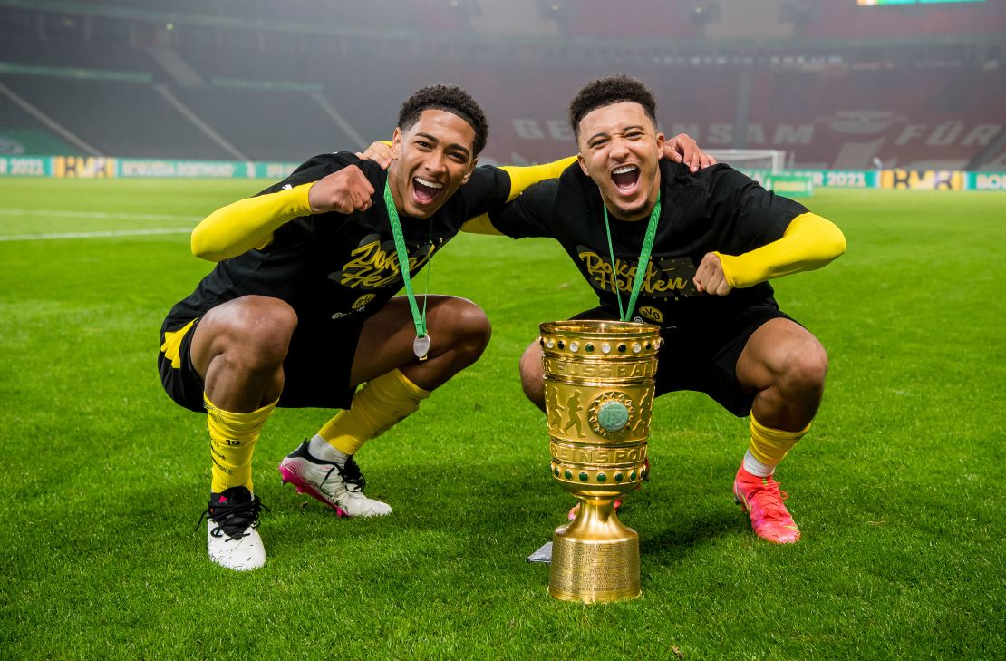 Bellingham and Sancho celebrate after winning the German Cup against RB Leipzig at the Olympic Stadium on May 13, 2021, in Berlin.