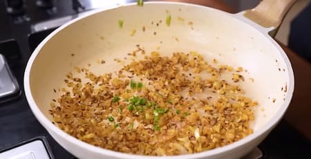 Onions and spices sautéing in mustard oil.