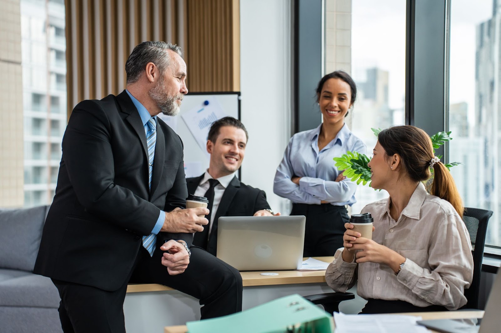  A group of business people acting joyful and friendly during a meeting.