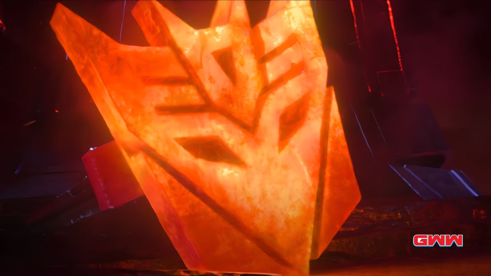 Glowing orange Decepticon symbol on a dark background.