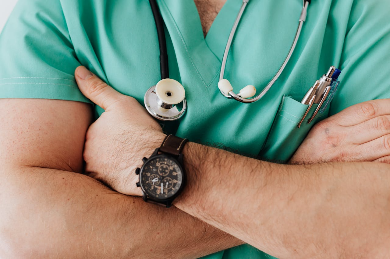 Image of a medical professional with arms crossed from pexels https://www.pexels.com/photo/crop-unrecognizable-male-doctor-with-stethoscope-4021775/