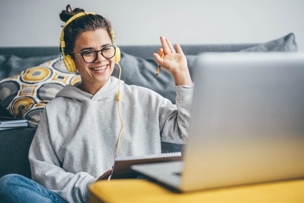 Patient portals and patient engagement: patient holding a notebook and a pencil while on a video call