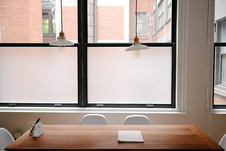 Kitchen table with safety glass wall in background