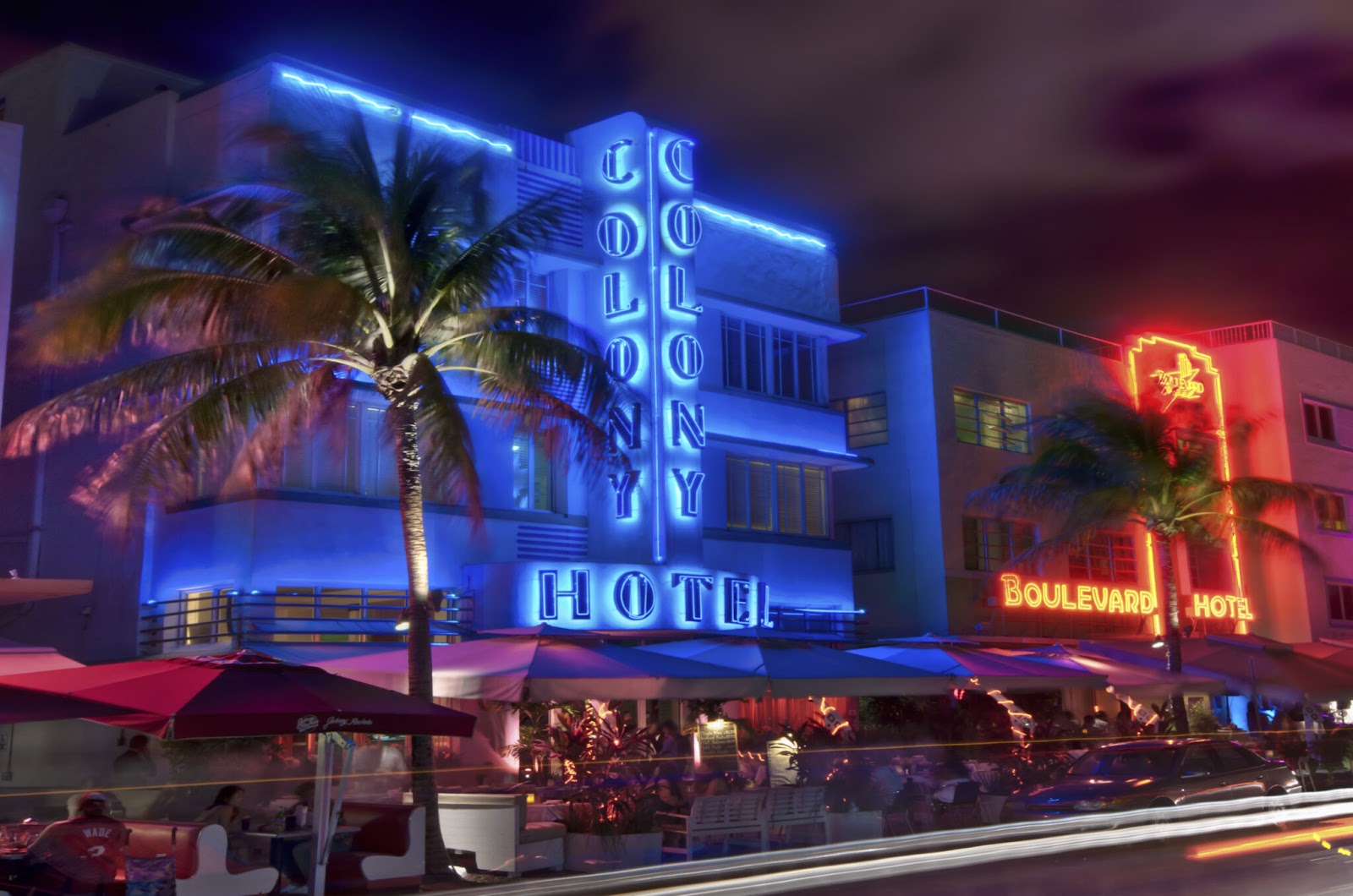 Hotels and cafés with neon lights and palm trees