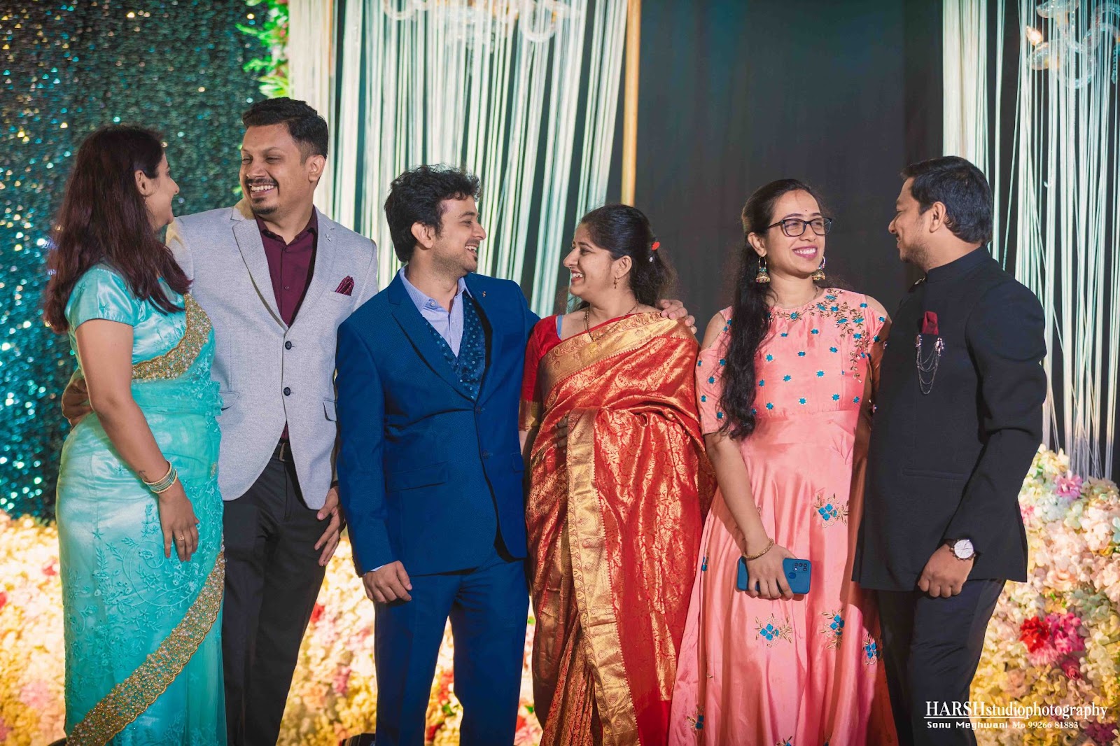 best photographer in indore - Harsh Studio Photography : Group wedding photo with coordinated outfits and height variation