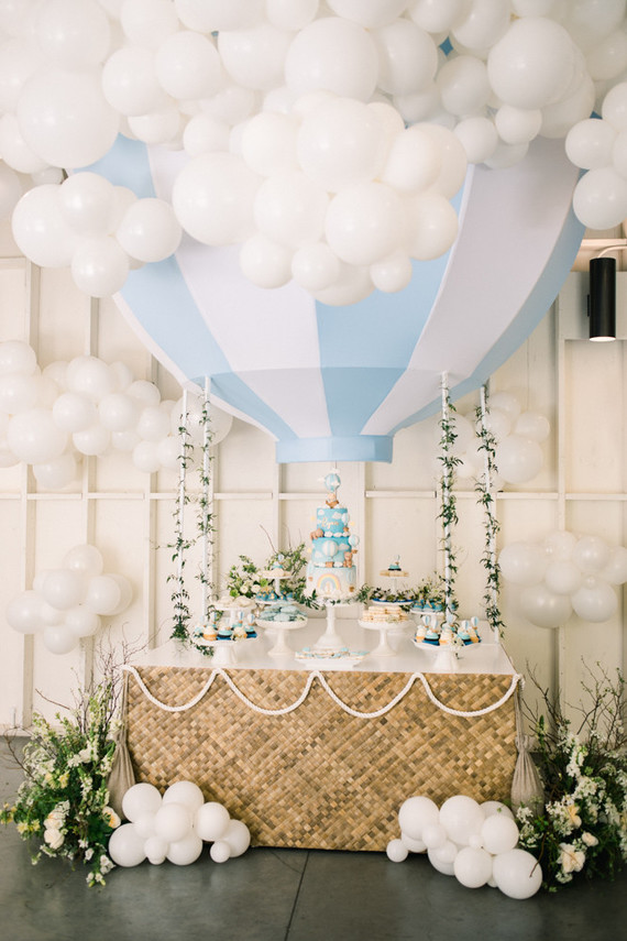 large hot air balloon decorated table with cake and desserts