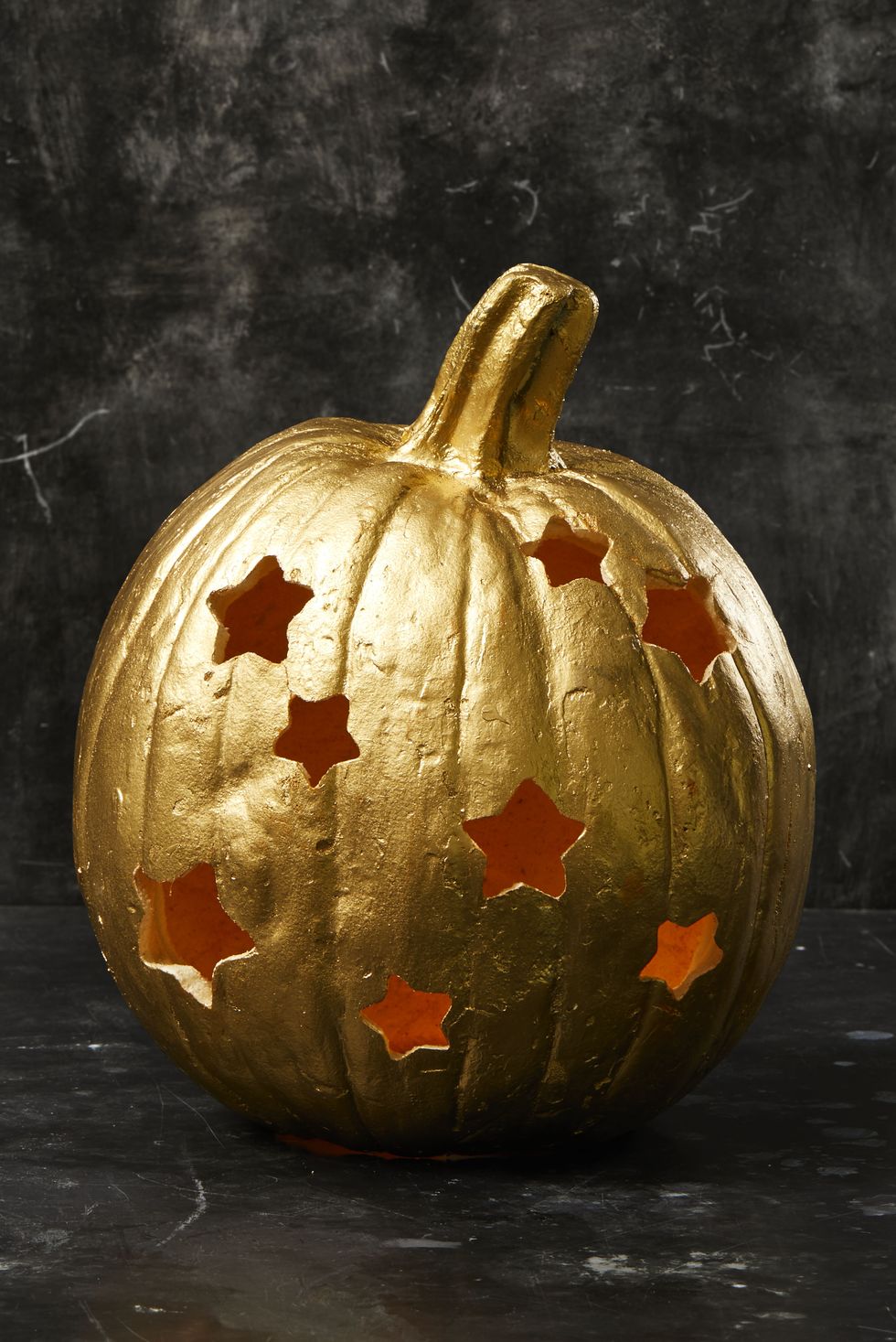 pumpkin carving ideas, gold painted pumpkin with star cutouts