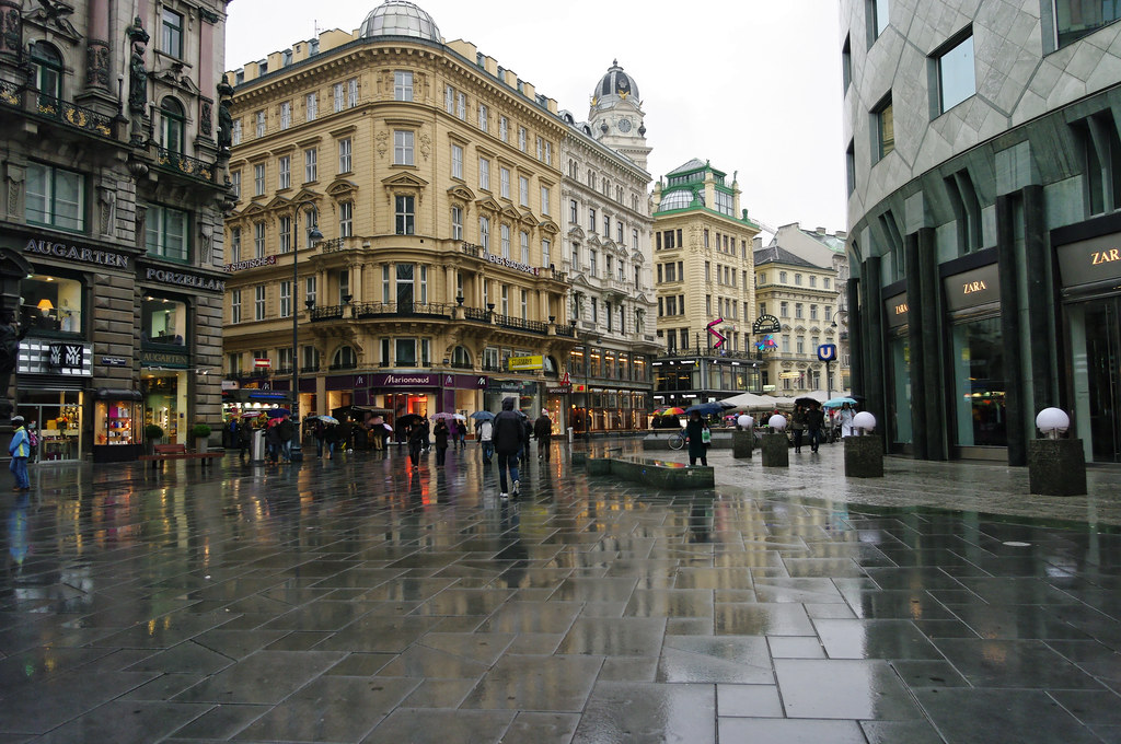 People on the streets of Austria on a rainy day.