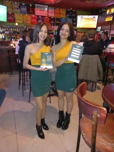 Two women holding a menu

Description automatically generated