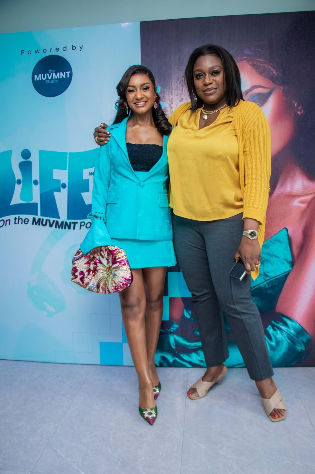 Two women posing for a picture

Description automatically generated