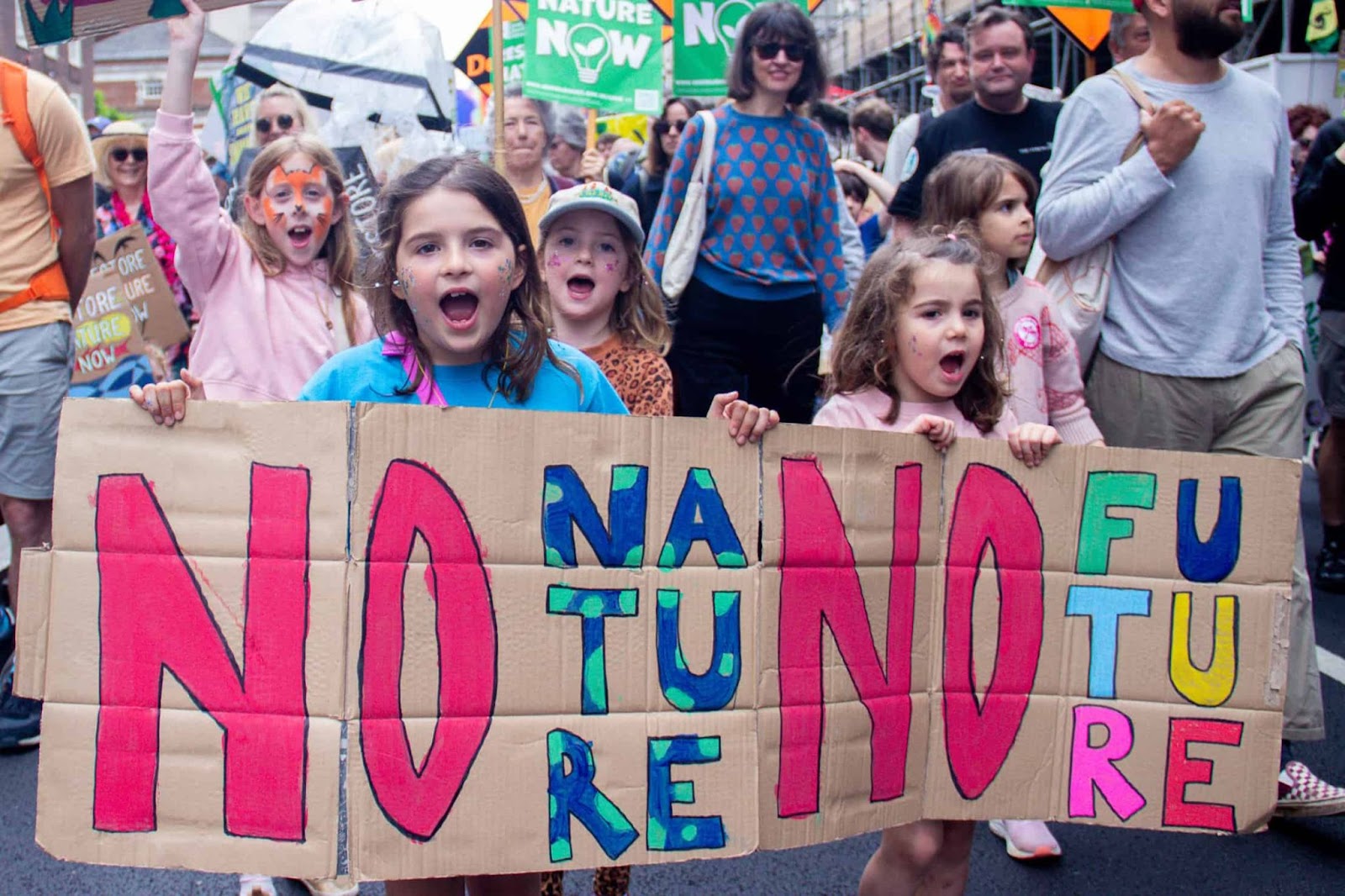 Children chant and hold a banner saying no nature, no future