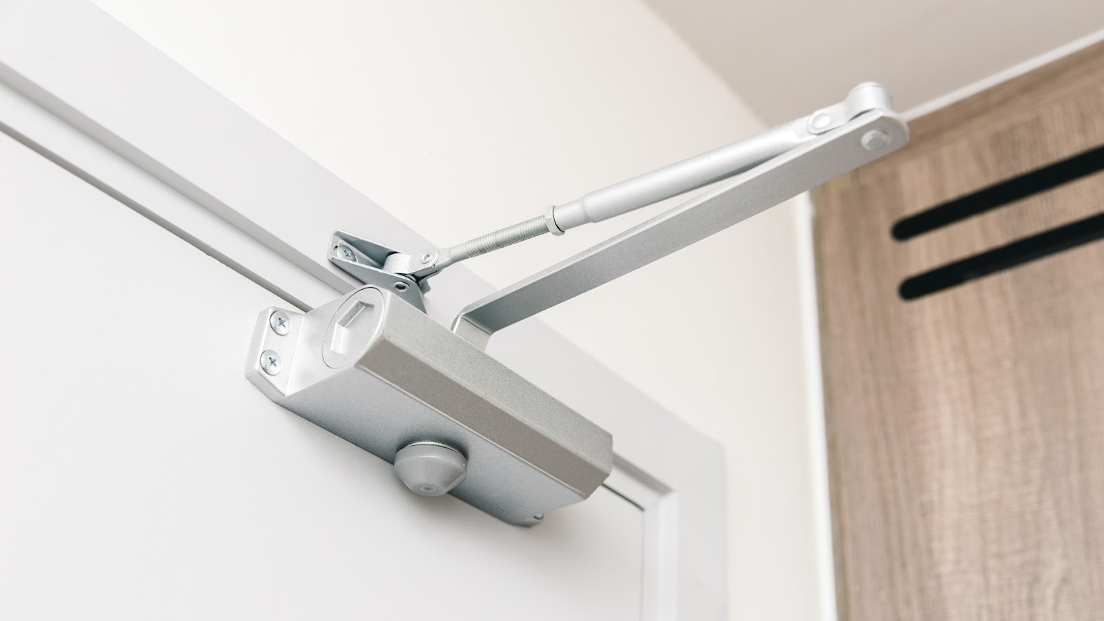 An automatic door closer mechanism mounted on a door enhances accessibility and security.