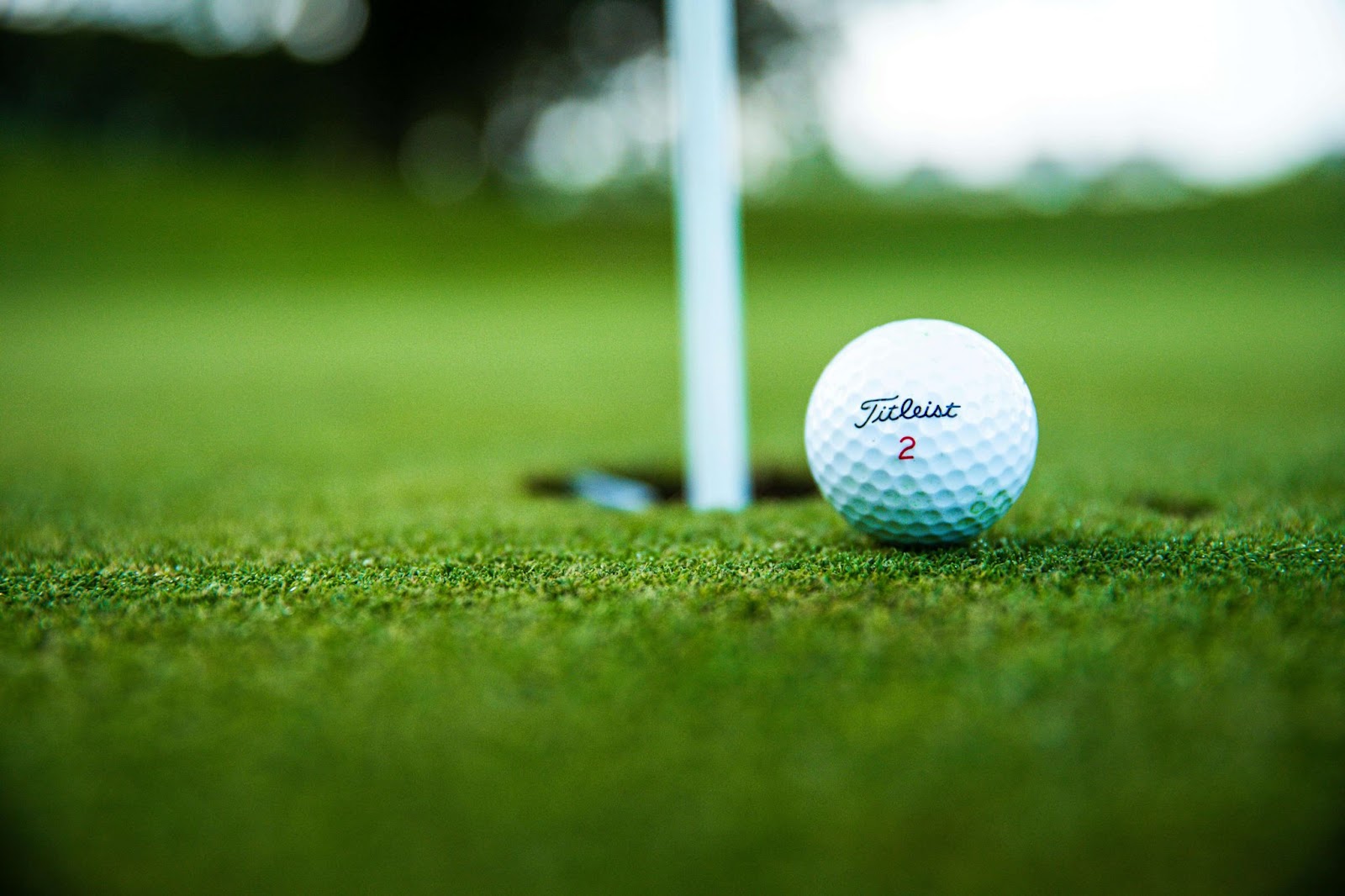 Titleist ball next to hole