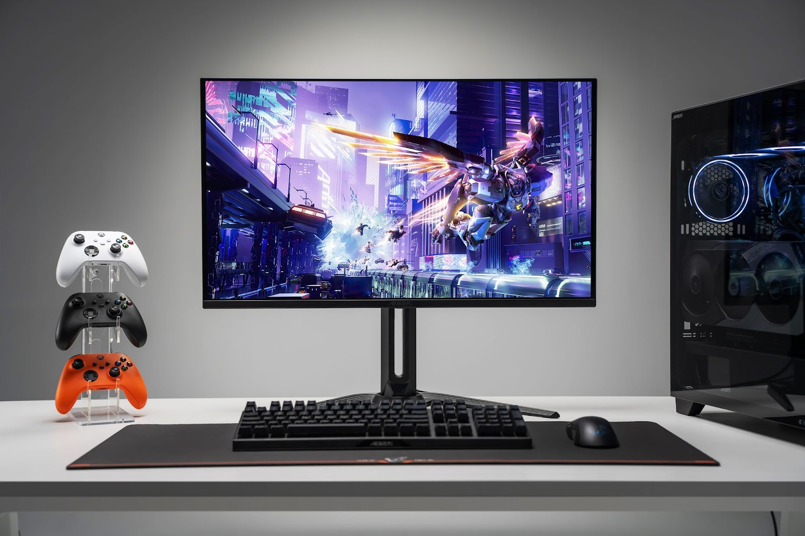 GIGABYTE monitor next to a controller tower and PC.