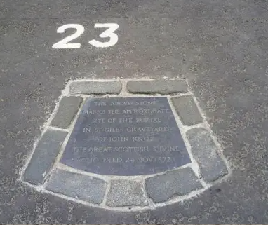 A plaque in the middle of a road

Description automatically generated