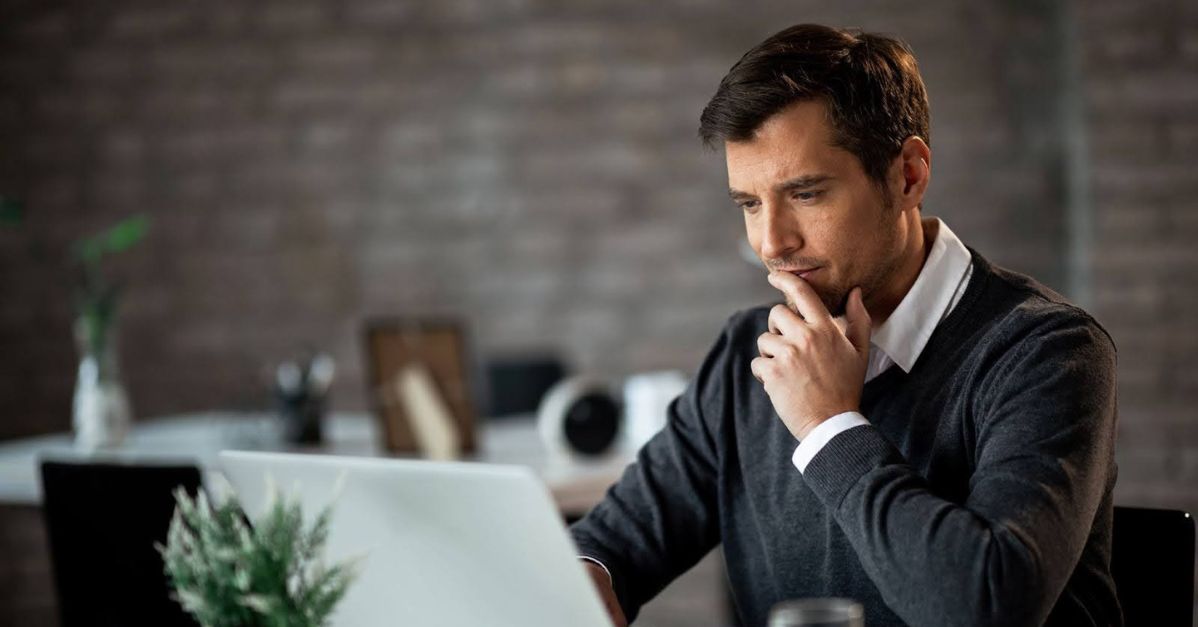 man studying information on a laptop