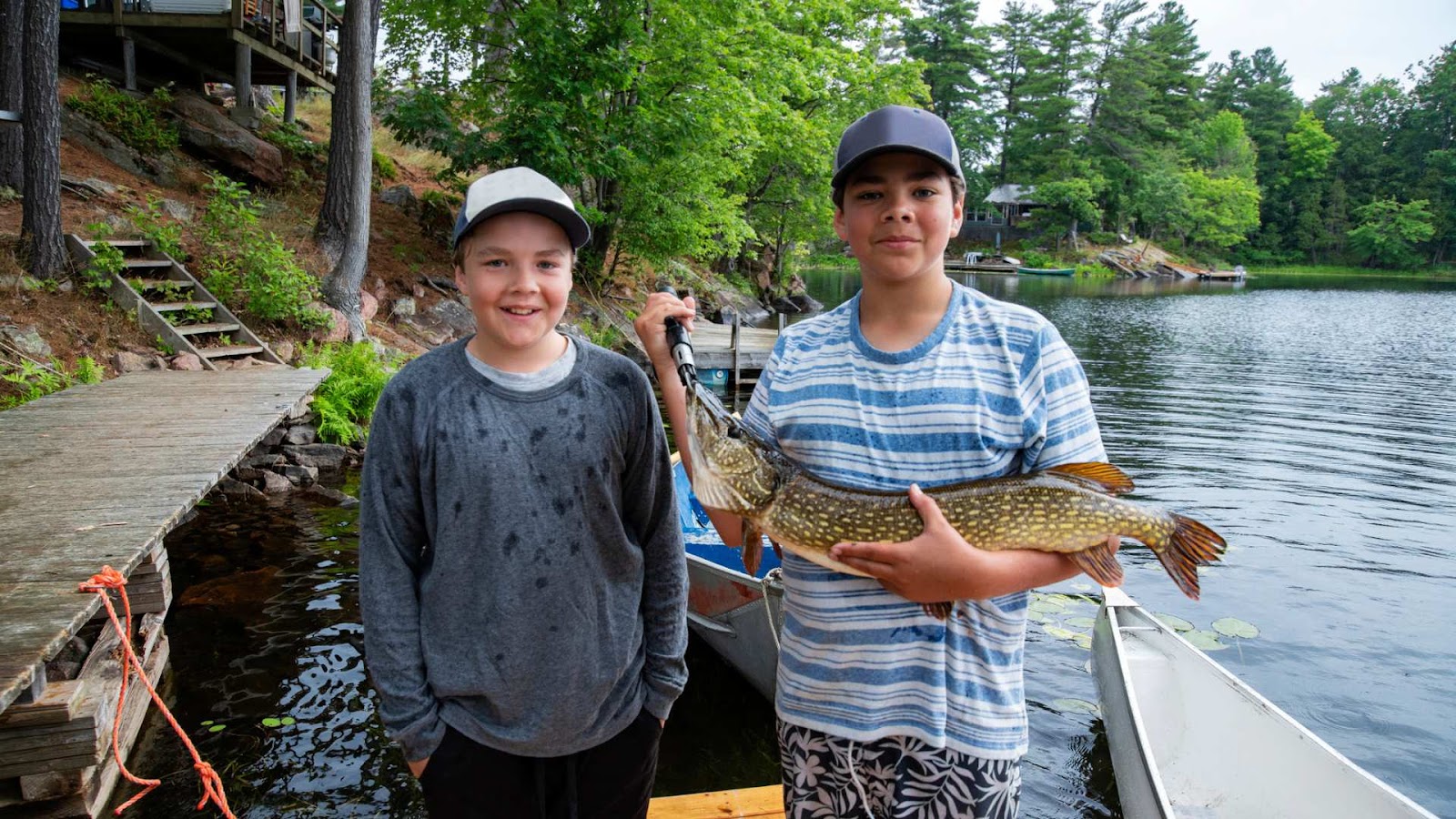 planning your pike fishing trip - two brother holding their big catch pike fish