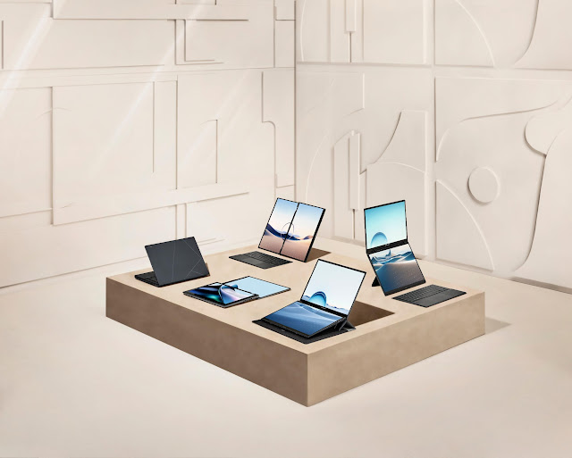 A group of laptops and tablets on a square tableDescription automatically generated