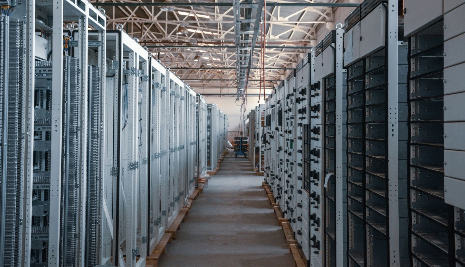 A data center aisle with rows of server racks on both sides.