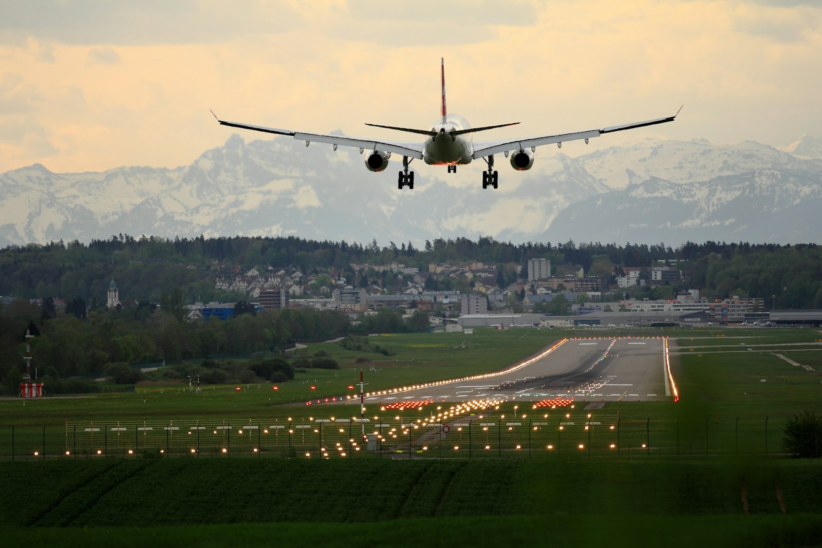 An airplane ascending into the sky from an airport runway.